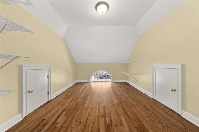 bonus room with hardwood / wood-style floors and lofted ceiling