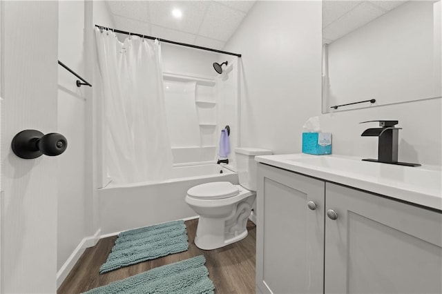 full bathroom featuring a drop ceiling, vanity, shower / bath combination with curtain, and wood-type flooring