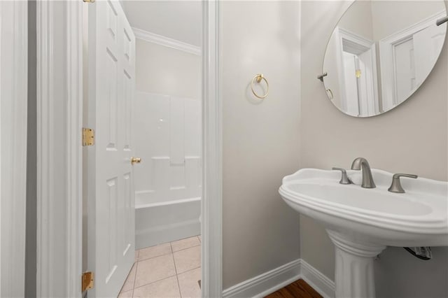 bathroom with tile patterned floors, ornamental molding, sink, and bathtub / shower combination