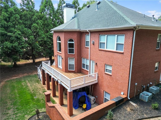 back of property with a wooden deck and cooling unit