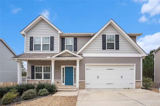 craftsman-style home featuring driveway, covered porch, an attached garage, and brick siding