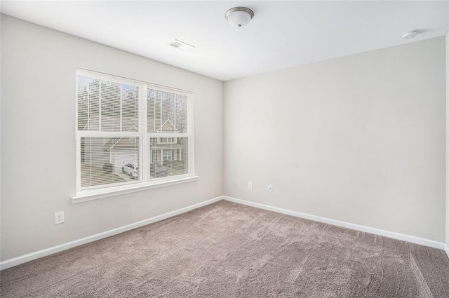 carpeted empty room with baseboards