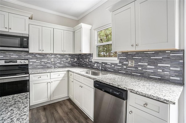 kitchen featuring tasteful backsplash, ornamental molding, a sink, and stainless steel appliances