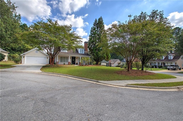 cape cod house featuring a garage and a front lawn