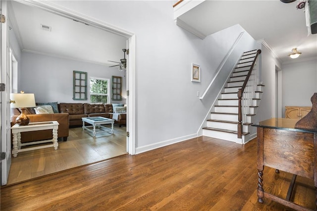 interior space featuring dark hardwood / wood-style flooring, crown molding, and ceiling fan