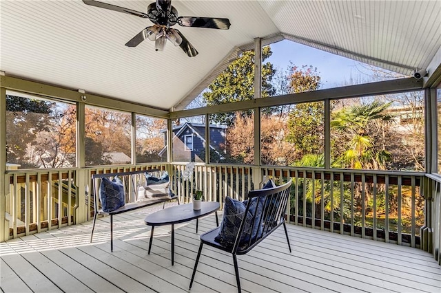 unfurnished sunroom with ceiling fan and vaulted ceiling