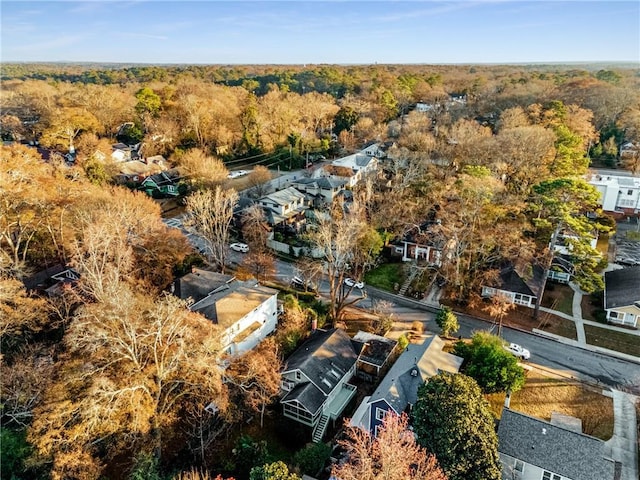 birds eye view of property featuring a forest view