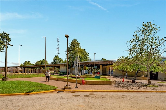 view of community featuring fence