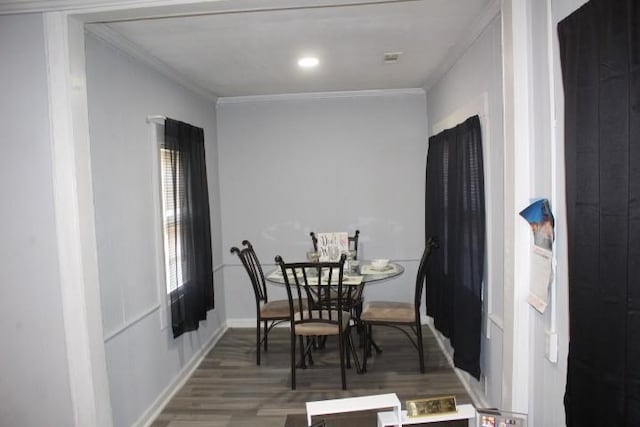 dining room featuring ornamental molding and hardwood / wood-style floors