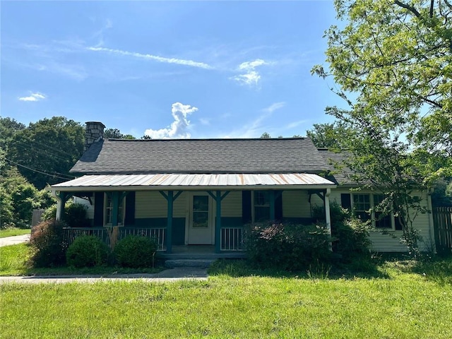 3517 Plunkett Rd, Stonecrest, GA 30038 - view of front of house with covered porch, a front yard, and a chimney