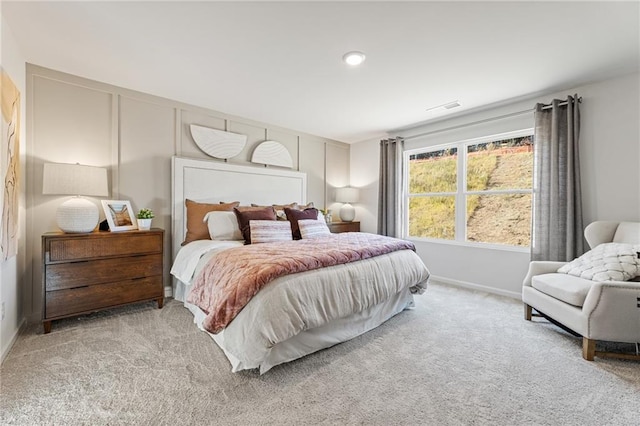 bedroom with visible vents, baseboards, and carpet