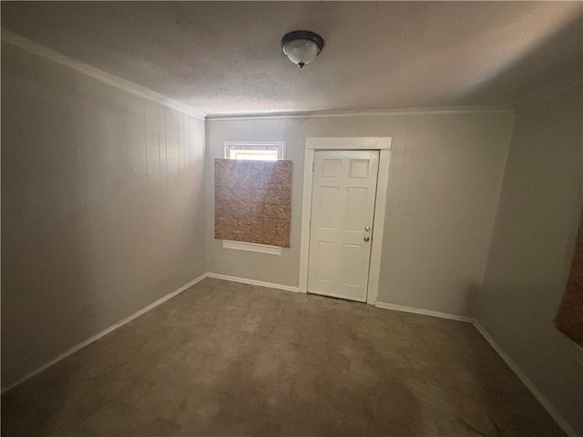 unfurnished room featuring a textured ceiling, baseboards, and ornamental molding