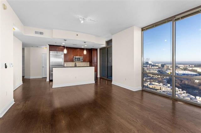 unfurnished living room with expansive windows and dark hardwood / wood-style floors