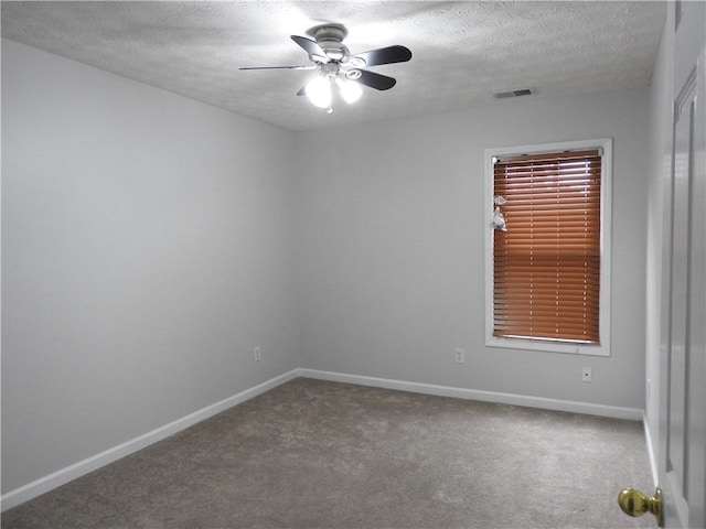 empty room featuring ceiling fan, carpet flooring, and a textured ceiling