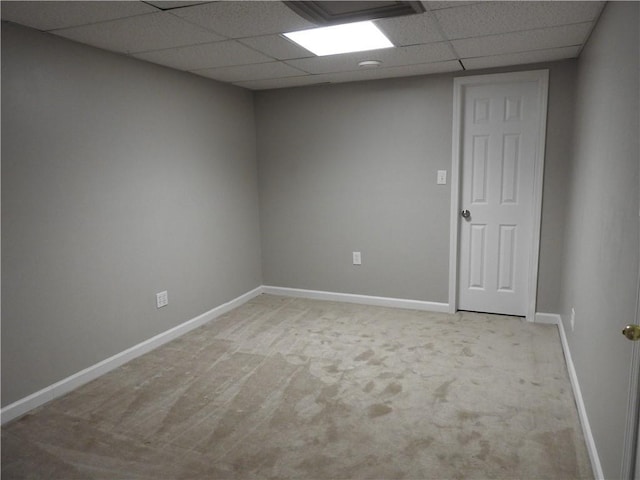 carpeted spare room with a paneled ceiling