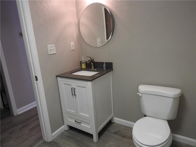 bathroom with vanity, hardwood / wood-style floors, and toilet