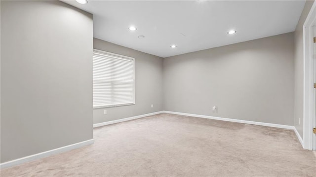 unfurnished room featuring recessed lighting, light carpet, and baseboards