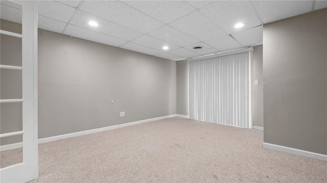 carpeted spare room featuring recessed lighting, a paneled ceiling, and baseboards