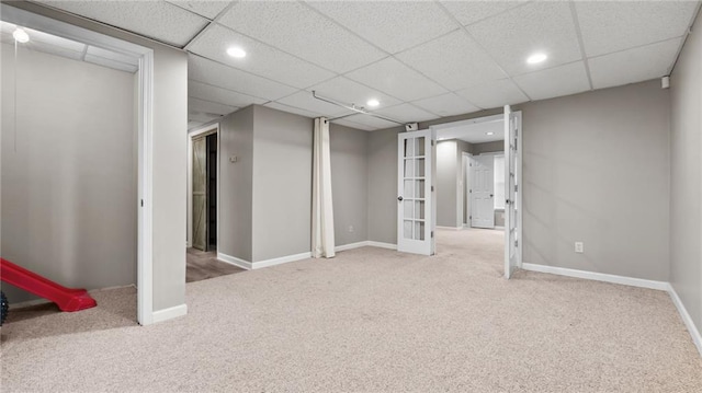 finished basement featuring french doors, recessed lighting, carpet flooring, and baseboards