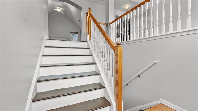 stairway featuring vaulted ceiling and baseboards