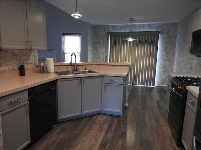 kitchen with sink, gray cabinetry, hanging light fixtures, dark hardwood / wood-style floors, and black appliances