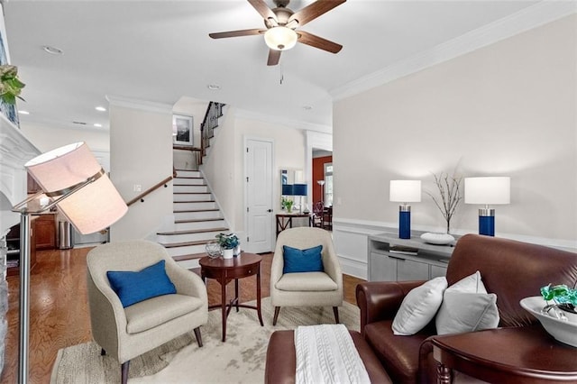1771 Silvergrass Ln, Grayson, GA 30017 - living area featuring ornamental molding, a ceiling fan, stairway, a wainscoted wall, and wood finished floors
