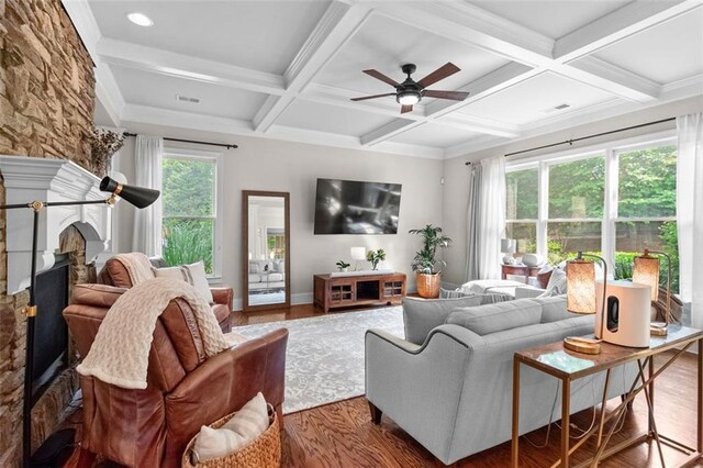 1771 Silvergrass Ln, Grayson, GA 30017 - living area featuring wood finished floors, coffered ceiling, ceiling fan, beamed ceiling, and a fireplace