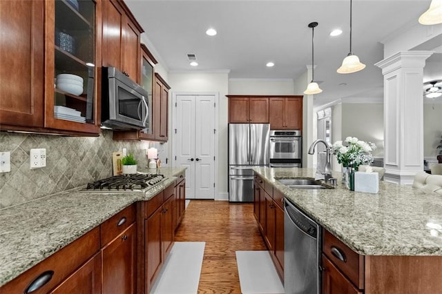 1771 Silvergrass Ln, Grayson, GA 30017 - kitchen with appliances with stainless steel finishes, ornate columns, light stone counters, backsplash, and ornamental molding