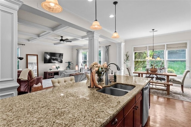 1771 Silvergrass Ln, Grayson, GA 30017 - kitchen with ornate columns, ceiling fan, beamed ceiling, plenty of natural light, and decorative light fixtures