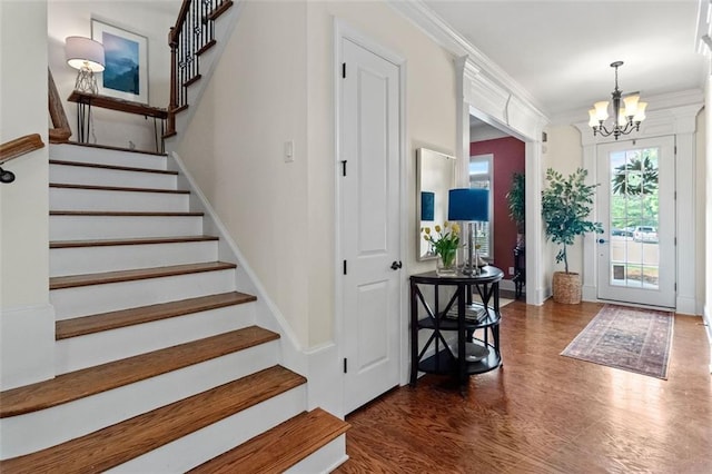 1771 Silvergrass Ln, Grayson, GA 30017 - foyer entrance featuring a chandelier, stairs, wood finished floors, and crown molding