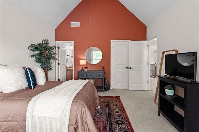 1771 Silvergrass Ln, Grayson, GA 30017 - bedroom with high vaulted ceiling, light carpet, and connected bathroom