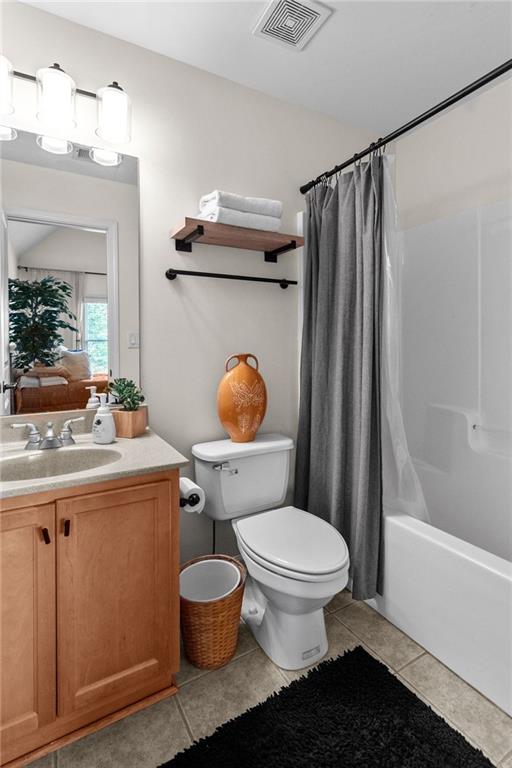 1771 Silvergrass Ln, Grayson, GA 30017 - bathroom with vanity, tile patterned flooring, and shower / tub combo