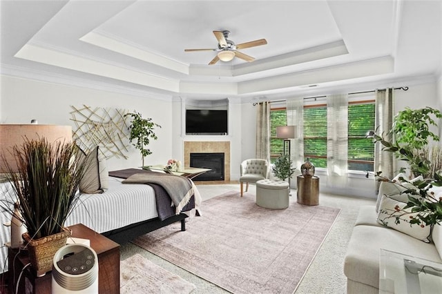 1771 Silvergrass Ln, Grayson, GA 30017 - bedroom with a raised ceiling, carpet floors, a tile fireplace, ornamental molding, and a ceiling fan