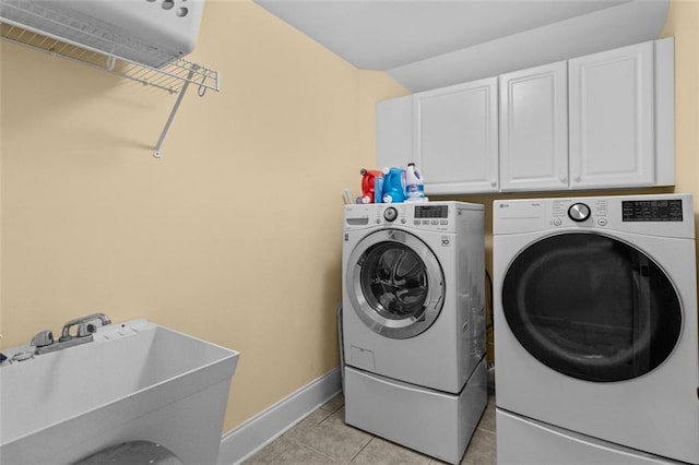 1771 Silvergrass Ln, Grayson, GA 30017 - washroom with cabinet space, washing machine and dryer, and light tile patterned floors