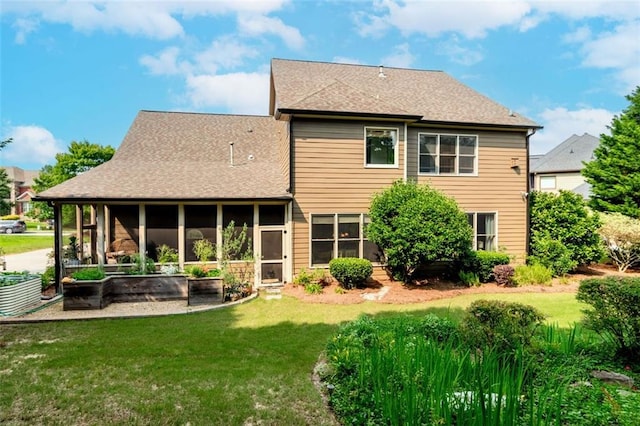 1771 Silvergrass Ln, Grayson, GA 30017 - back of property featuring a sunroom, a lawn, and roof with shingles