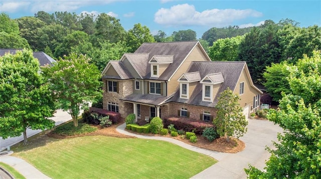 1771 Silvergrass Ln, Grayson, GA 30017 - view of front of house featuring driveway, a front yard, and stone siding