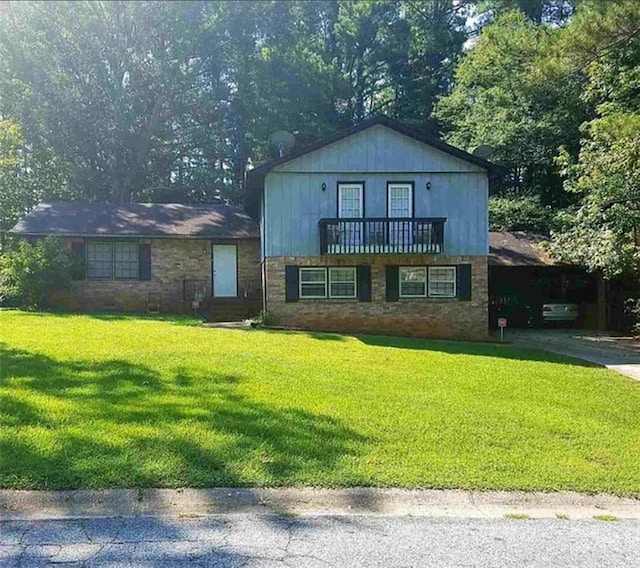 split level home featuring a front lawn and a balcony
