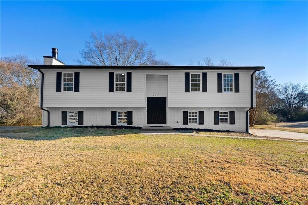 bi-level home featuring a front lawn