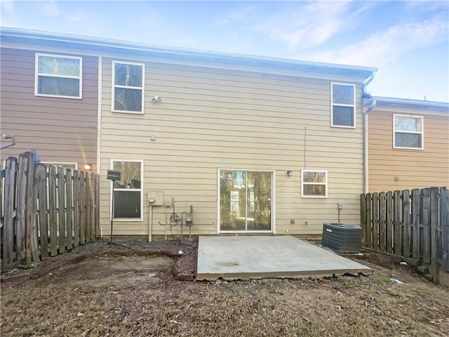 rear view of property featuring central AC and a patio area