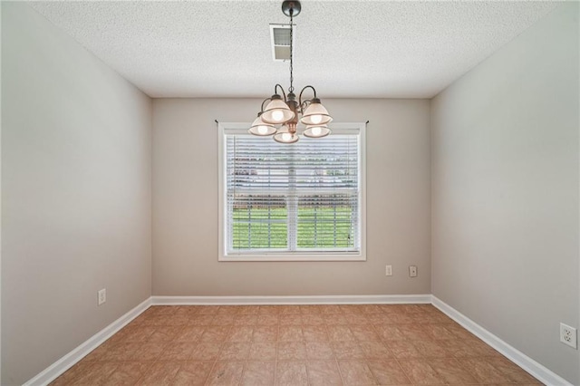 237 Raventree Ln, Griffin, GA 30224 - spare room featuring a chandelier and a textured ceiling