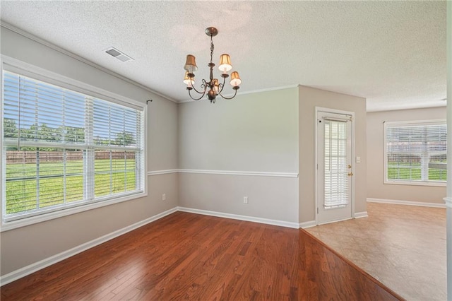 237 Raventree Ln, Griffin, GA 30224 - empty room featuring a chandelier, a textured ceiling, and wood finished floors