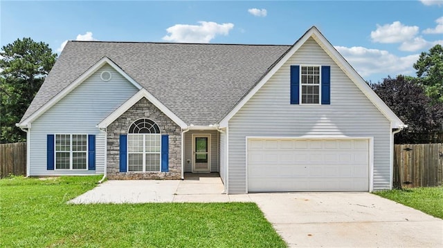 237 Raventree Ln, Griffin, GA 30224 - traditional-style house with driveway, stone siding, roof with shingles, and an attached garage