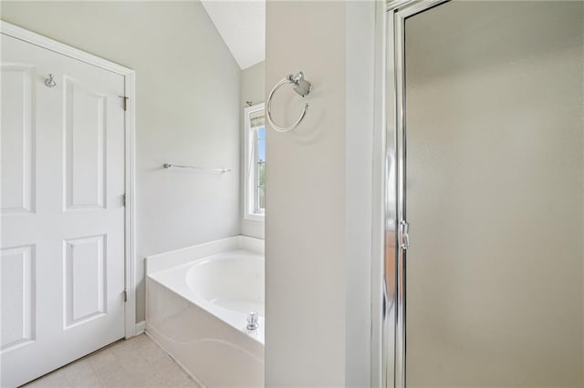 237 Raventree Ln, Griffin, GA 30224 - bathroom with a garden tub, a shower with shower door, vaulted ceiling, and tile patterned flooring