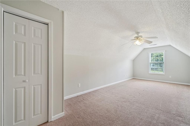 237 Raventree Ln, Griffin, GA 30224 - additional living space featuring a textured ceiling, lofted ceiling, a ceiling fan, and carpet flooring