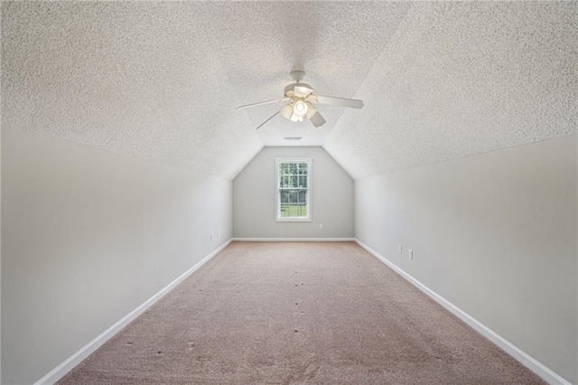 237 Raventree Ln, Griffin, GA 30224 - additional living space featuring a textured ceiling, a ceiling fan, vaulted ceiling, and carpet floors