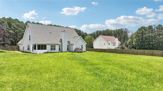 237 Raventree Ln, Griffin, GA 30224 - back of property featuring a chimney, a shingled roof, and view of wooded area