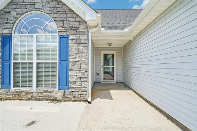 237 Raventree Ln, Griffin, GA 30224 - view of exterior entry featuring stone siding and roof with shingles