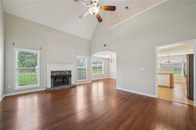 237 Raventree Ln, Griffin, GA 30224 - unfurnished living room featuring a chandelier, ceiling fan, healthy amount of natural light, high vaulted ceiling, and a fireplace