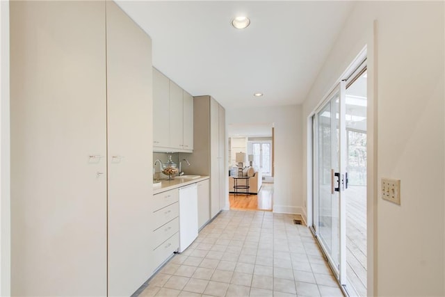 kitchen featuring white dishwasher and sink