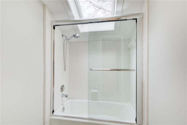 bathroom featuring bath / shower combo with glass door